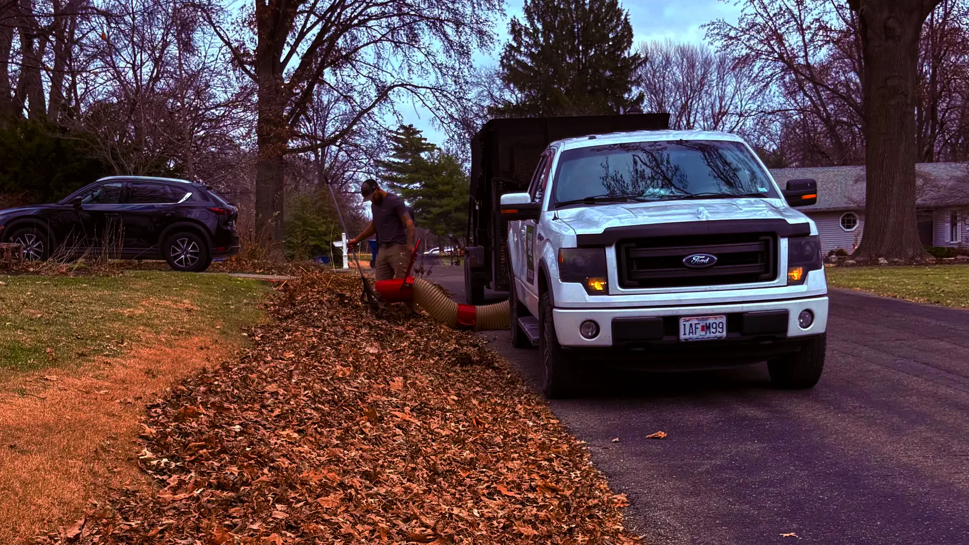 Curbside leaf pickup service collecting fallen leaves along the street in St. Charles County, Missouri
